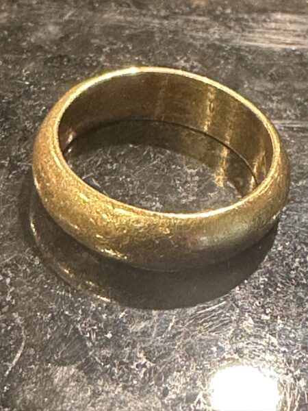 A recovered gold band photographed after cleaning off the sand