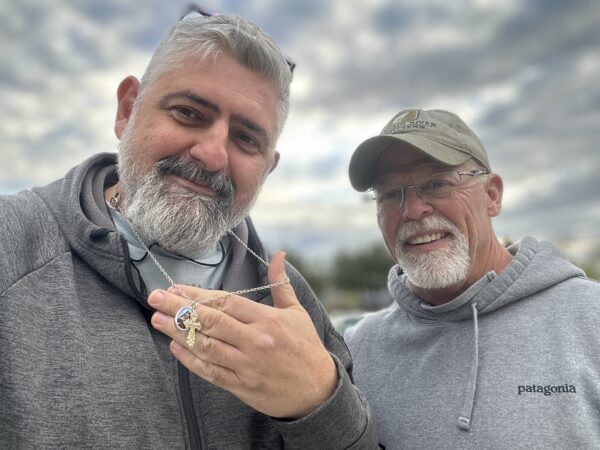 Dave with a client holding a recovered necklace and ring